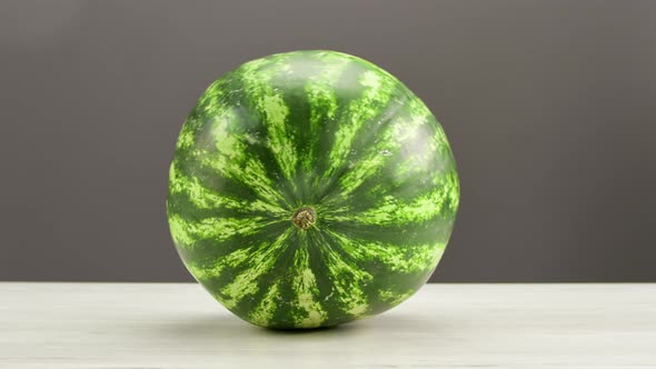 Appetizing Refreshing Tasty Watermelon with Green Striped Peel Lying on Wooden Table Isolated