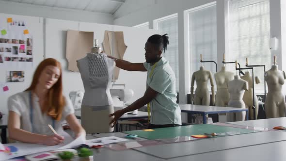 Mixed race man working in fashion office