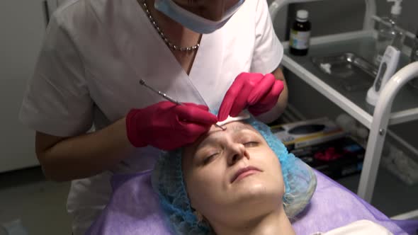 Beautician doing face cleaning treatment using mechanical instrument