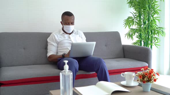 Portrait of ill black american business man wearing a face mask for corona virus