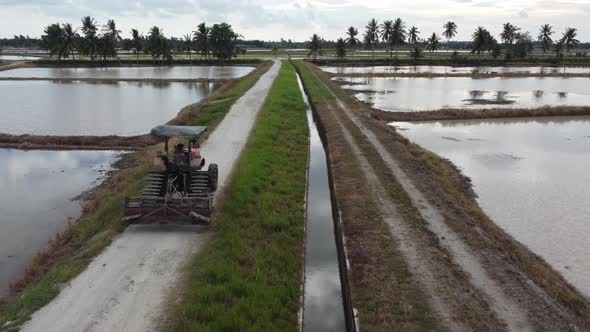 Follow tractors move at rural path