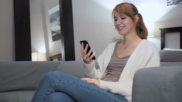 Online Video Chat on Smartphone by Woman in Couch