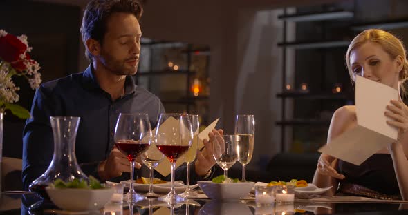 Beautiful Elegant Couple Choose What to Eat in a Restaurant