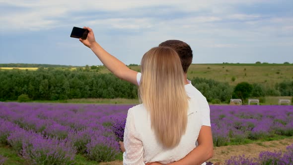 Lovers Take a Selfie in a Lavender Field