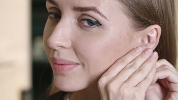 Woman Enjoying New Earrings in Store