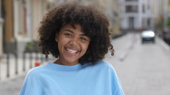 Outdoor Portrait of Laughing Curly Mixed Race Girl