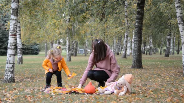 Mother and a Small Daughter, Spends Time Together in a City Park on a Picnic