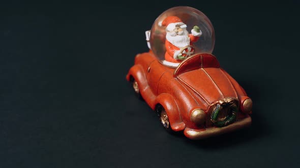Winter Toy Santa Claus in a Red Car Brings Gifts