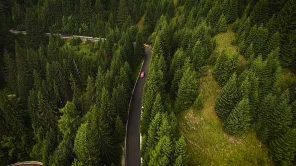 Car Driving On The Forested Road In The Mountains