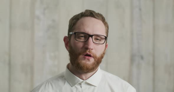 Bearded Handsome Man in Glasses Yawns Wearily