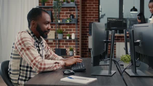 Software Developer Typing Programming Code on Computer Keyboard Turning Head and Smiling