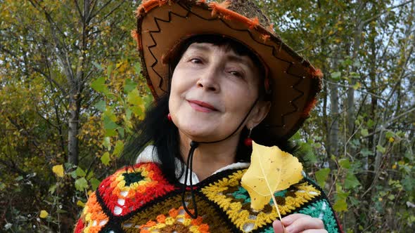 Portrait of Alone Attractive Positive Mature Adult Woman Who Smiles in Fall in Park.