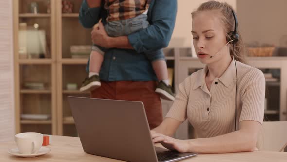 Partner with Kid Distracting Working Woman