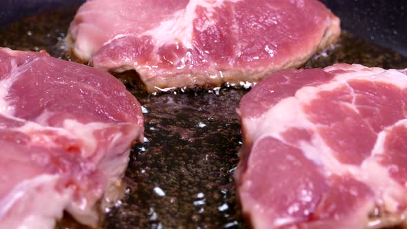 A Piece of Raw Meat Is Fried in Oil