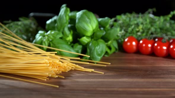 Super Slow Motion Shot of Fresh Spaghetti Falling on Italian Decorated Wooden Table at 1000Fps