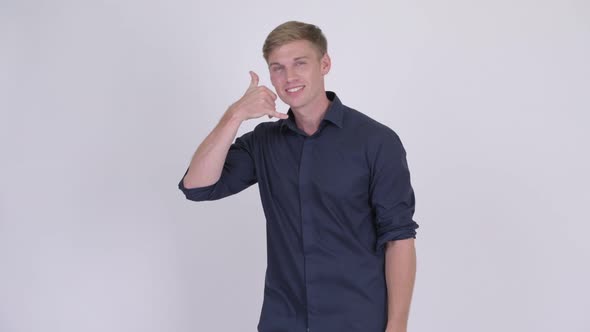 Young Happy Blonde Businessman with Call Me Gesture