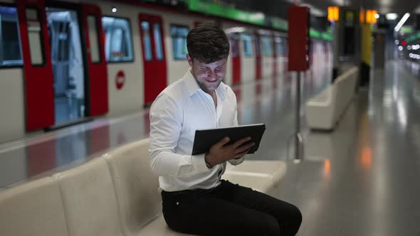 Businessman Using Tablet in Subway