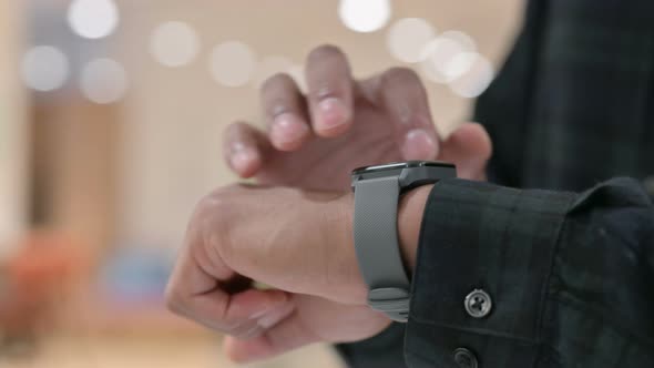 Close Up of African Hands Using Smart Watch