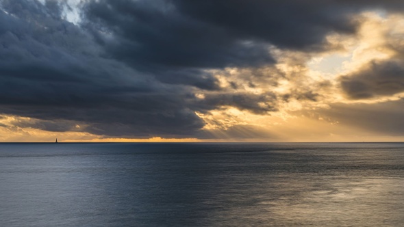 Timelapse Sunset with Light Rays above ocean with Cordouan Light House, France