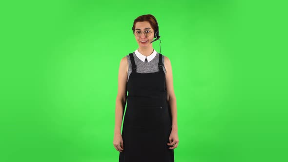 Funny Girl in Round Glasses with Headset Helping with Customer Service and Worry. Green Screen