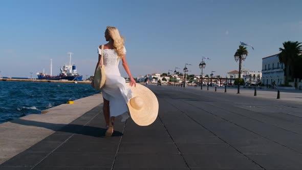Beautiful Girl Tourist Walking on Spetses Embankment Greece
