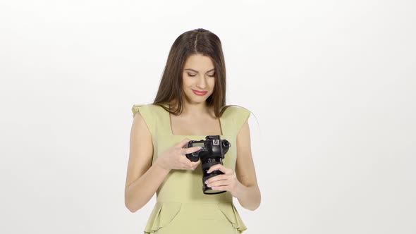 Girl Looks at the Results of the Photo Shoot on the Camera Screen