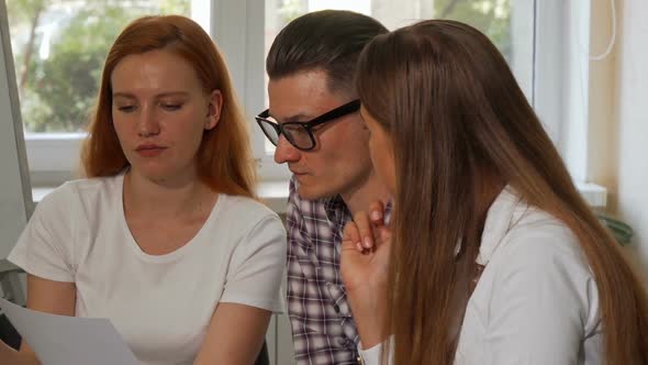 Group of Businesspeople Examining Documents Together