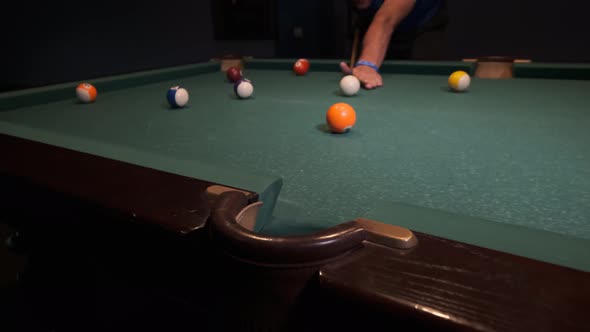 Billiard balls with numbers on a pool table. Playing pool billiards in a night bar