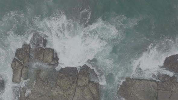 Waves Crash Against Rocks in the Ocean