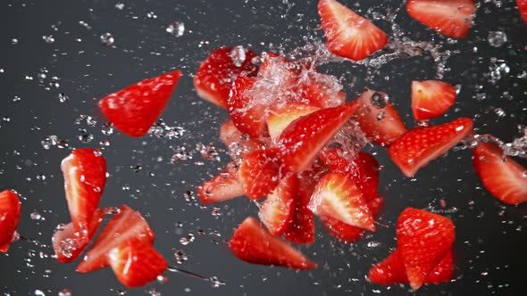 Super Slow Motion Shot of Fresh Strawberries and Water Side Collision on Grey Background at 1000Fps