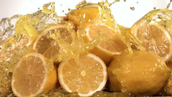 Slow Motion Shot of Lemon Juice Splashing Through Lemon Slices