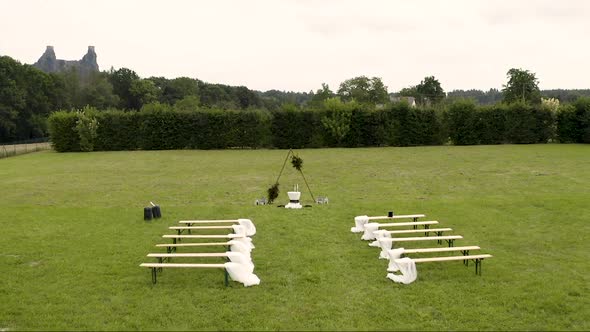 Wedding altar and benches prepared for an outdoor garden wedding.