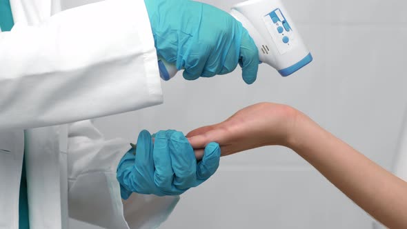 Close Up Shot of Doctor Measuring Body Temperature on Wrist of Female Patient Slow Motion