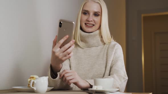 Attractive Pretty Female Student Young Woman Girl Using Mobile Phone Drinking Coffee in Evening Cafe