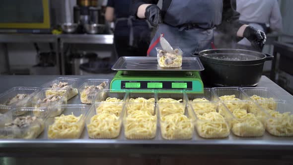Chef Prepares Takeaway Food in Plastic Containers Pasta and Mushrooms Charity Lunch Small Business
