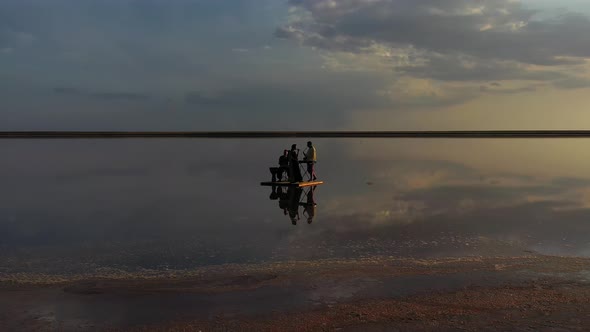 Aerial Footage of Musicians Playing Ethnic Music in the Sea, Reflection Clouds