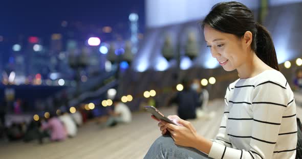 Woman use of smart phone in city 