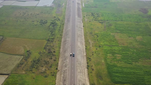 Aerial view of a road among the fields in Sapahar, Rajshahi, Bangladesh.