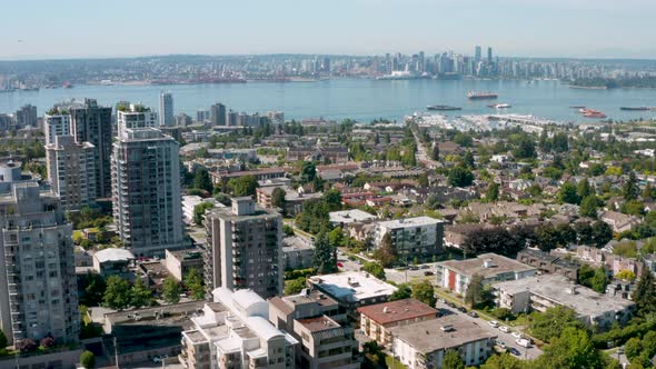 Rising aerial view of the scenic downtown skyline from North Vancouver, British Columbia.