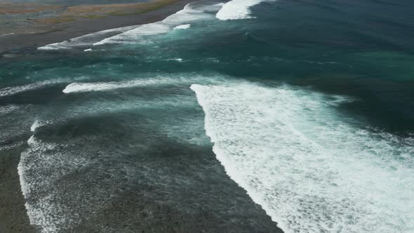 Huge ocean waves and surf breaking on a rocky reef