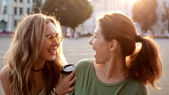 Two Happy Young Girls Hug Each Other