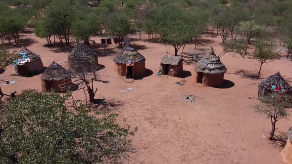 The village of a native tribe Himba in the forests of Namibia, aerial shot