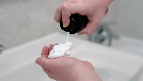 Little Boy Applying Shaving Foam to Hand in the Bathroom