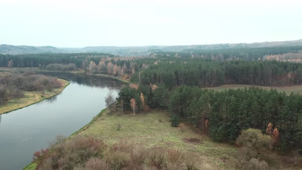 AERIAL: Gloomy And Foggy Autumn Landscape View with River Neris