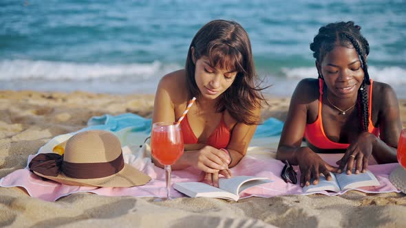 Two Student Girls Preparing for Tests on Sandy Beach