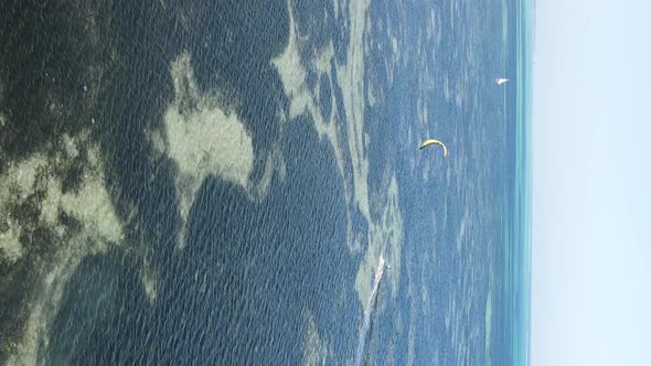 Zanzibar Tanzania  Vertical Video Kitesurfing Near the Shore of Ocean Slow Motion