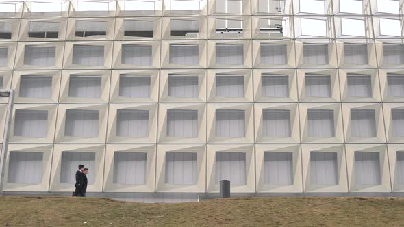 Businessmen walking by a modern building