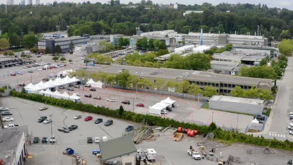 Queue Of Cars In A Drive-Thru COVID-19 Vaccine Site In Canada. - aerial ascend