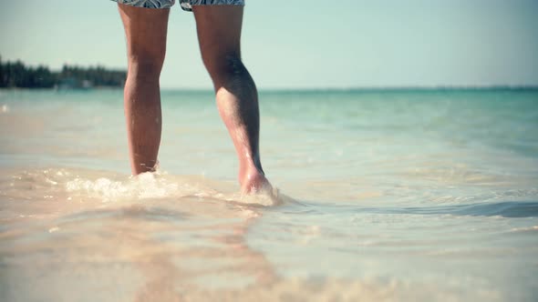 Man Legs Walking On Tropical Beach.Man Walking On Sund Beach Ocean.Man In Shorts Resting On Ocean
