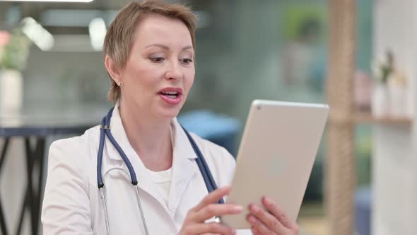 Video Call By Middle Aged Female Doctor on Tablet 